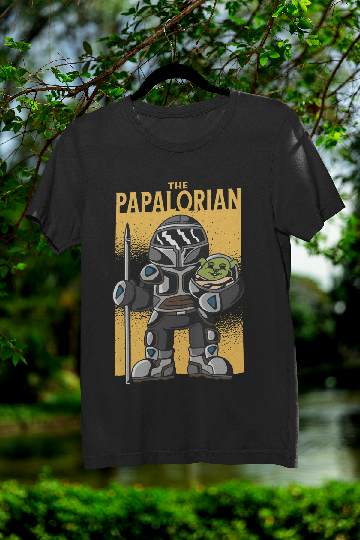 'The Papalorian' t-shirt in black, hanging outdoors among green trees
