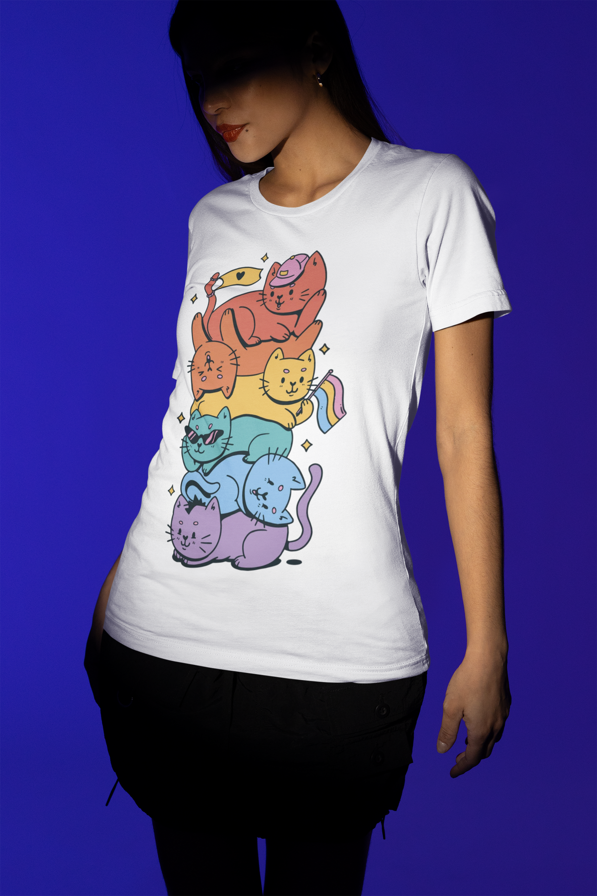 'Pride Stack of Cats' t-shirt in white, woman model wearing it against a blue background
