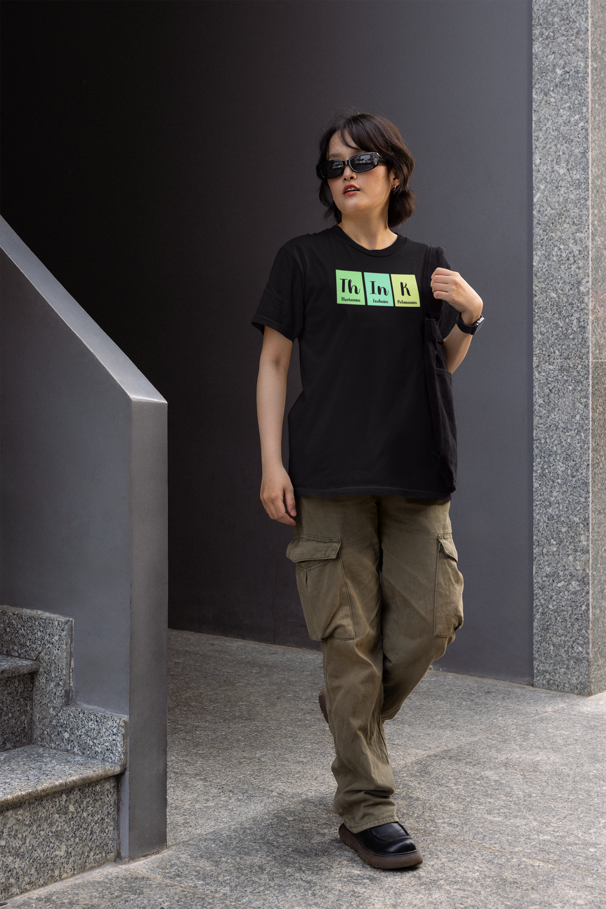 'Think' periodic table t-shirt in black, woman wearing it on stairs outdoors, funny science pun thinker gift