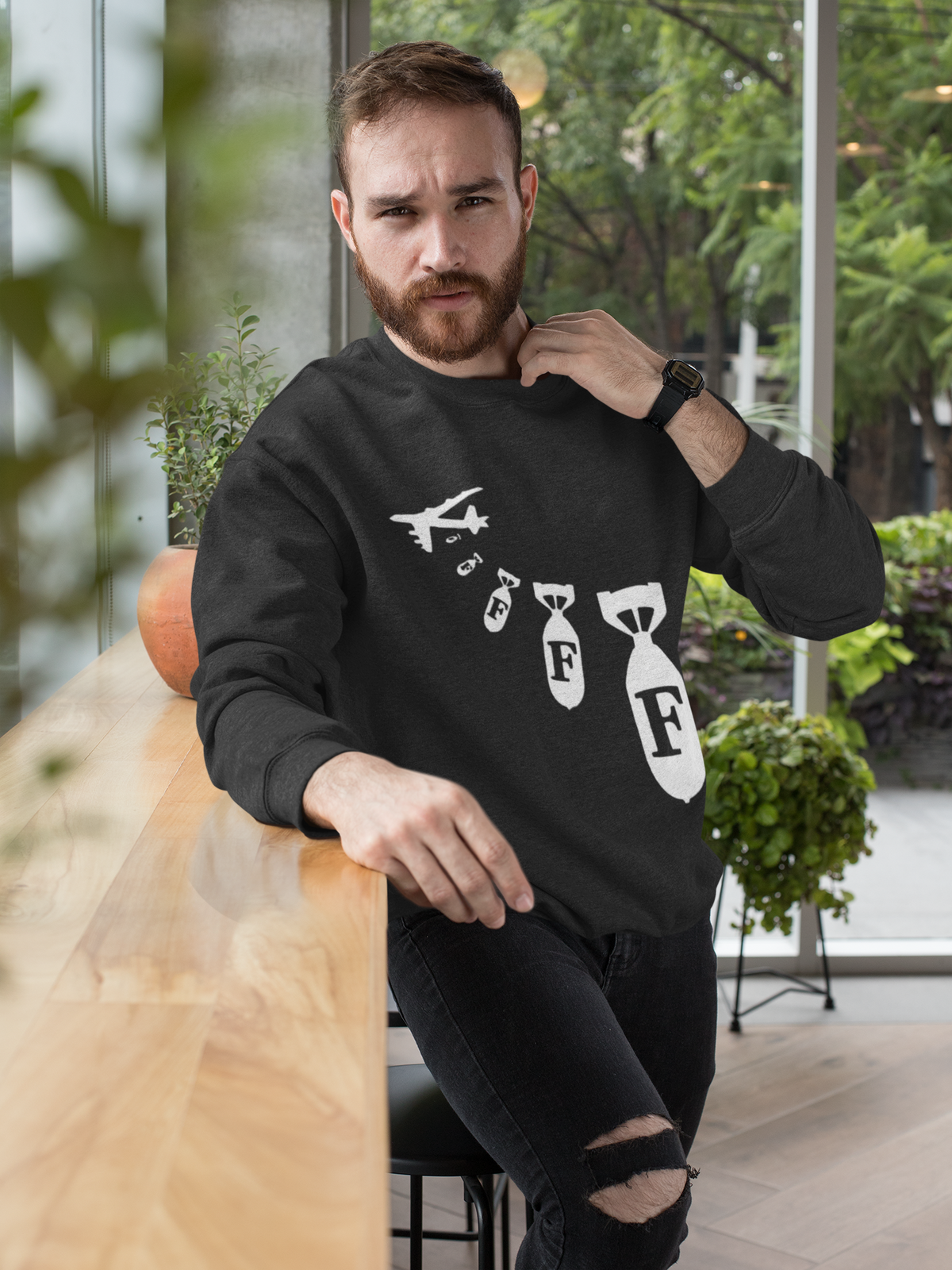 "F Bomb" sweatshirt in black, bearded man wearing it near a window, funny sarcastic gift sweatshirt