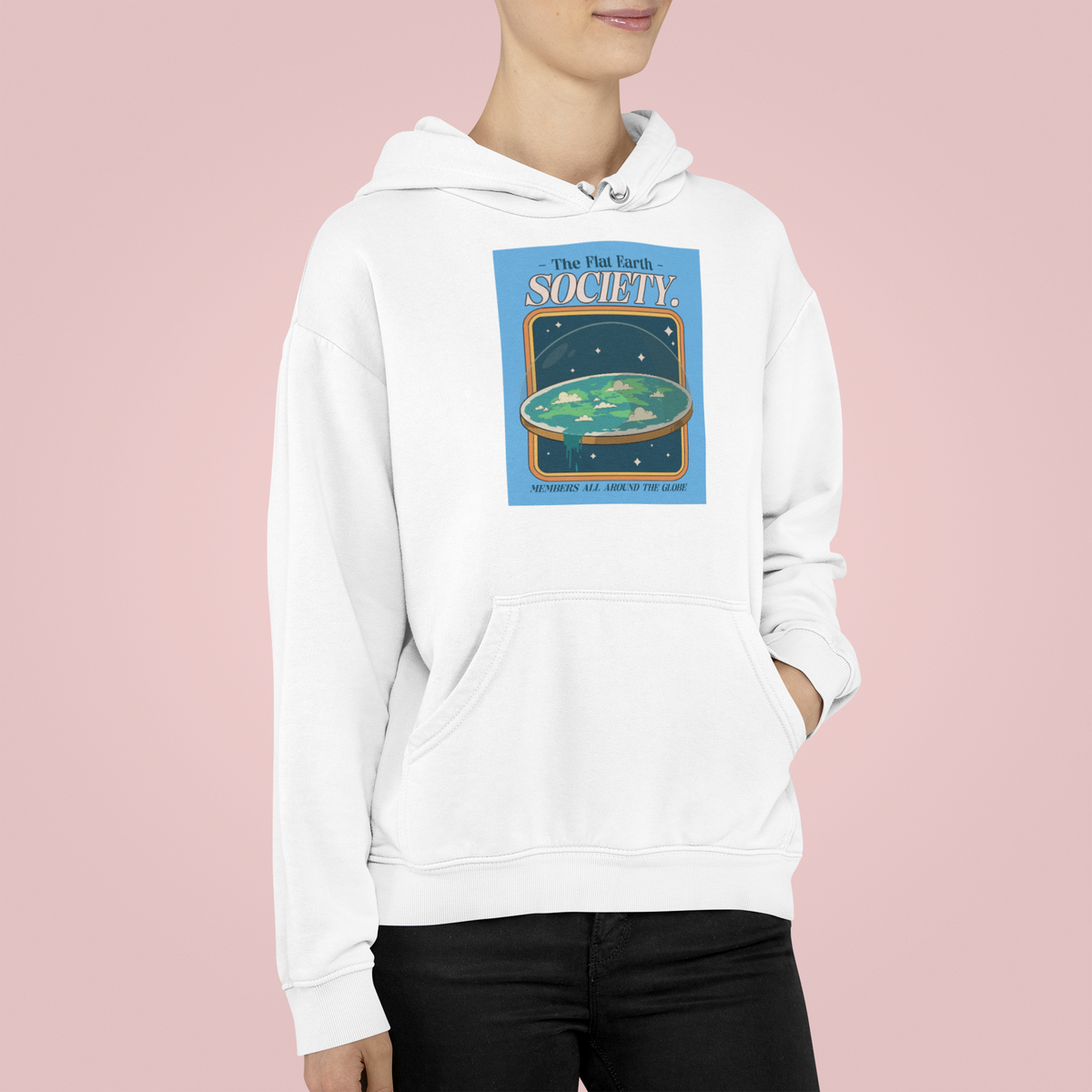 'Flat Earth Society' funny retro badge hoodie in white, woman wearing it, pink background, funny gift