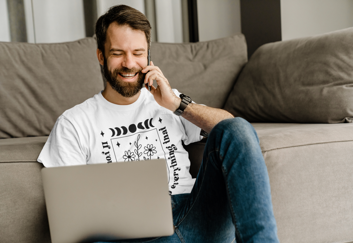 'If You Want To Fly' floral t-shirt in white, man on the phone wearing it