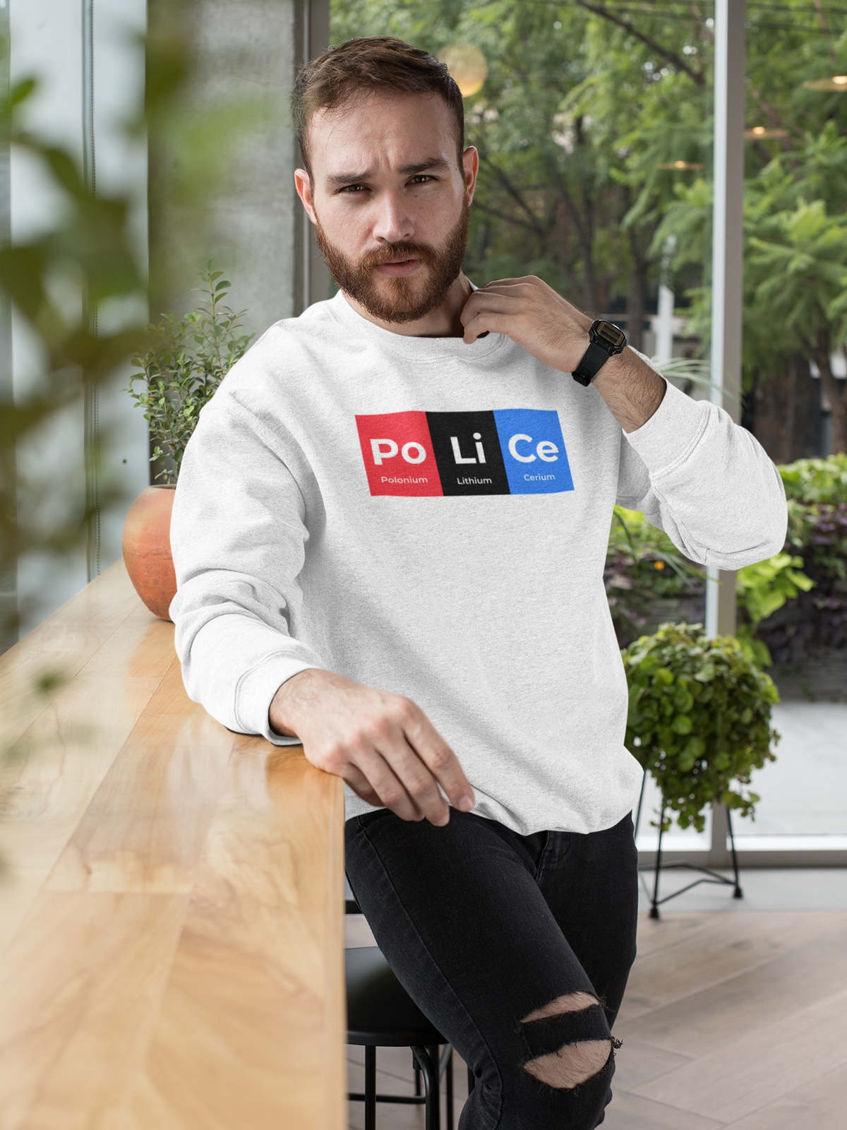 'Po-Li-Ce' periodic table sweatshirt in heather grey, man wearing it outdoors, funny chemistry pun gift