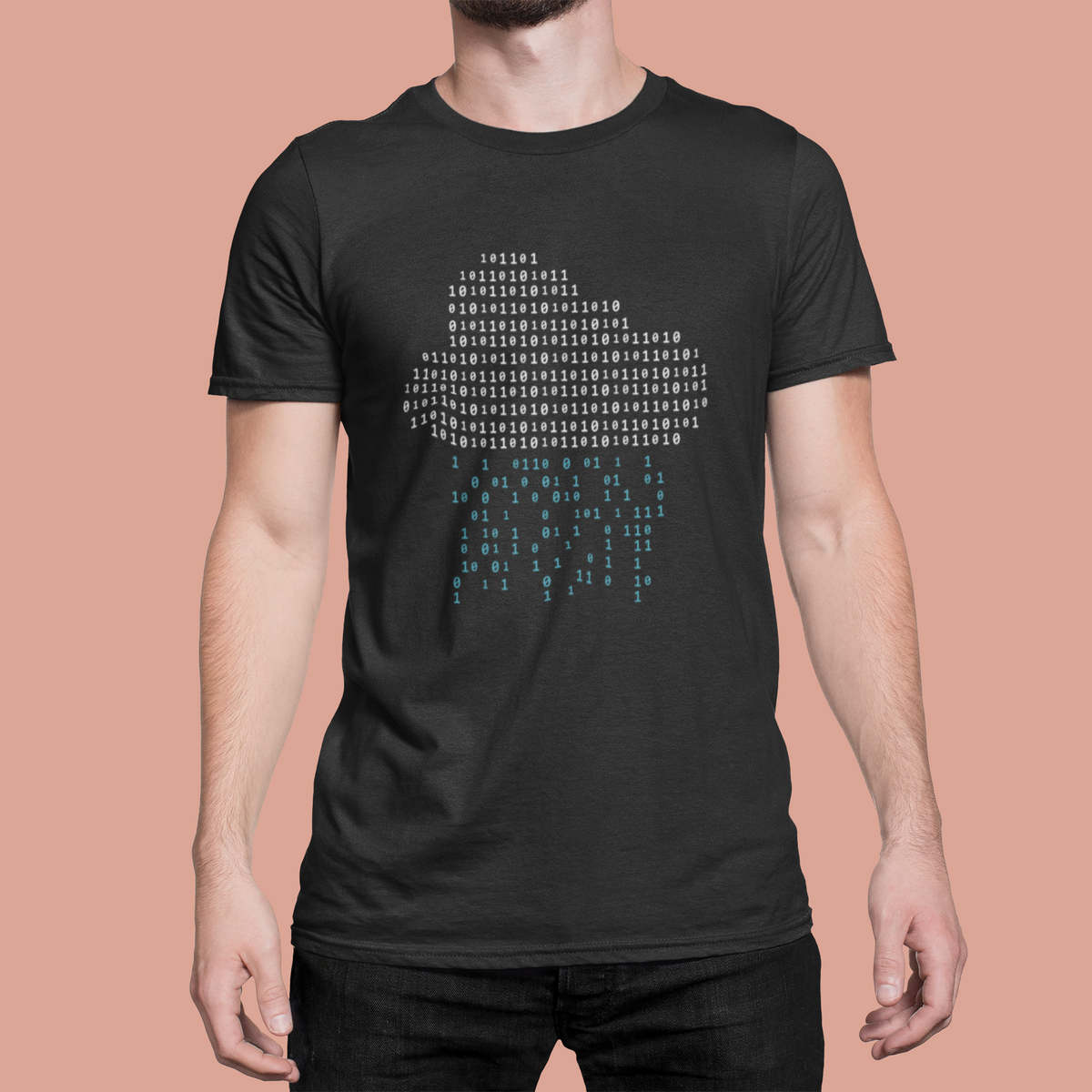 'It's Raining Code' cloud binary t-shirt in black, man model wearing it against a peach background, funny geek gift