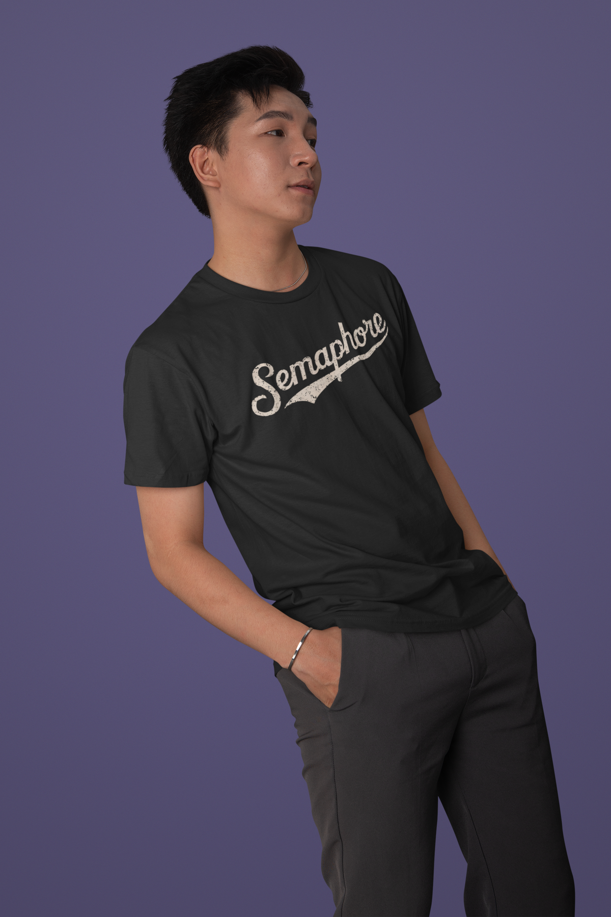 'Semaphore' script logo t-shirt in black, man wearing it on purple background, funny gift for programmers