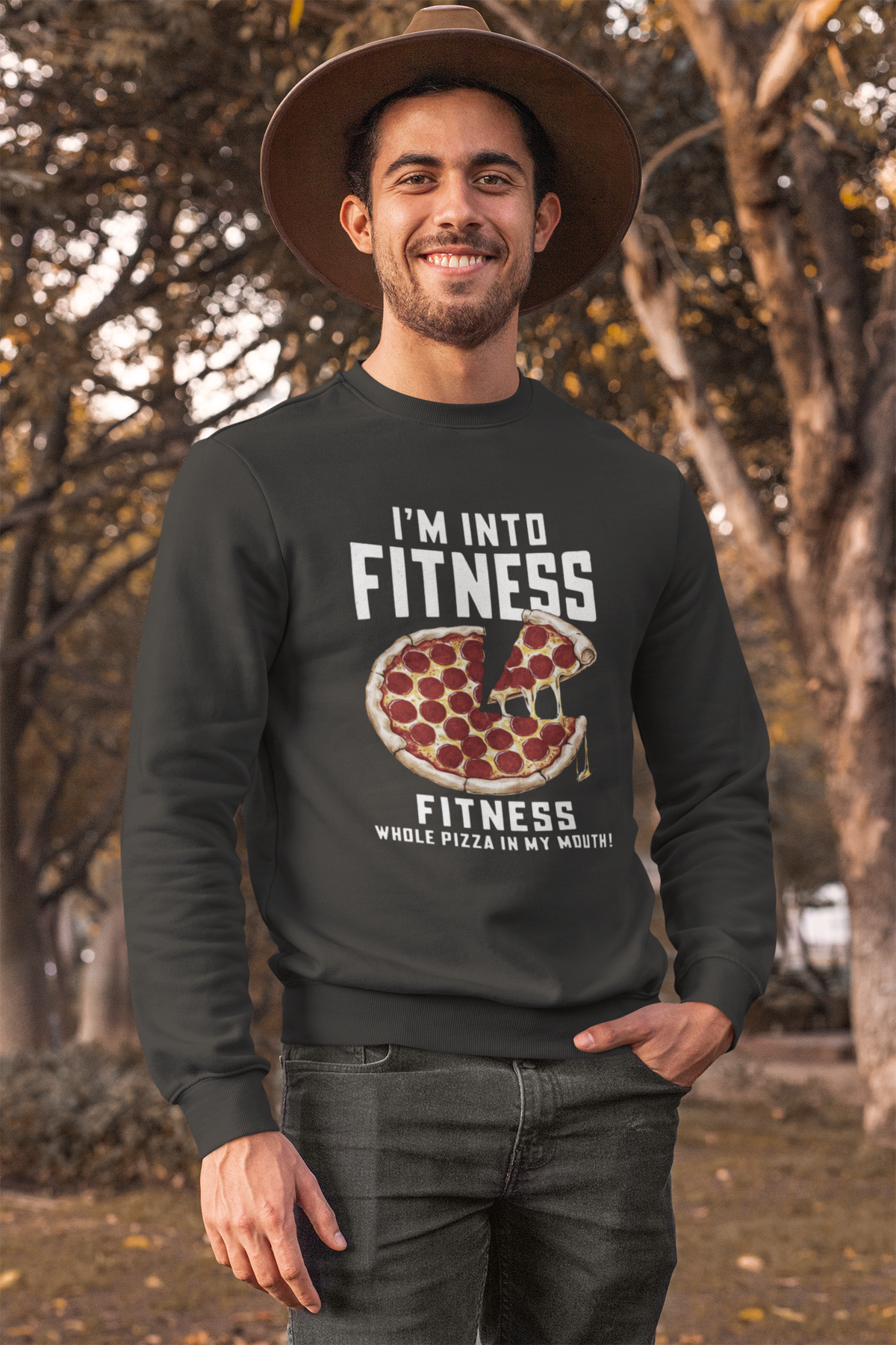 'I'm Into Fitness' pizza sweatshirt in black, man wearing it outdoors in a park, funny gift for pizza lovers