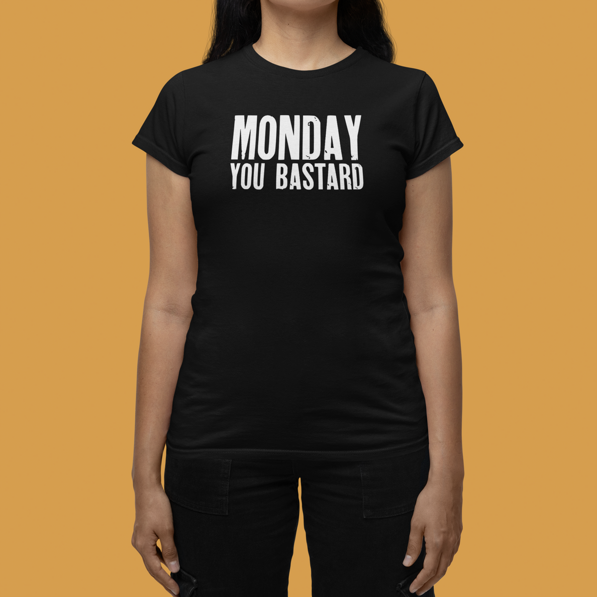 'Monday You Bastard' women's t-shirt in black, close-up on model, orange backdrop, funny Monday gift