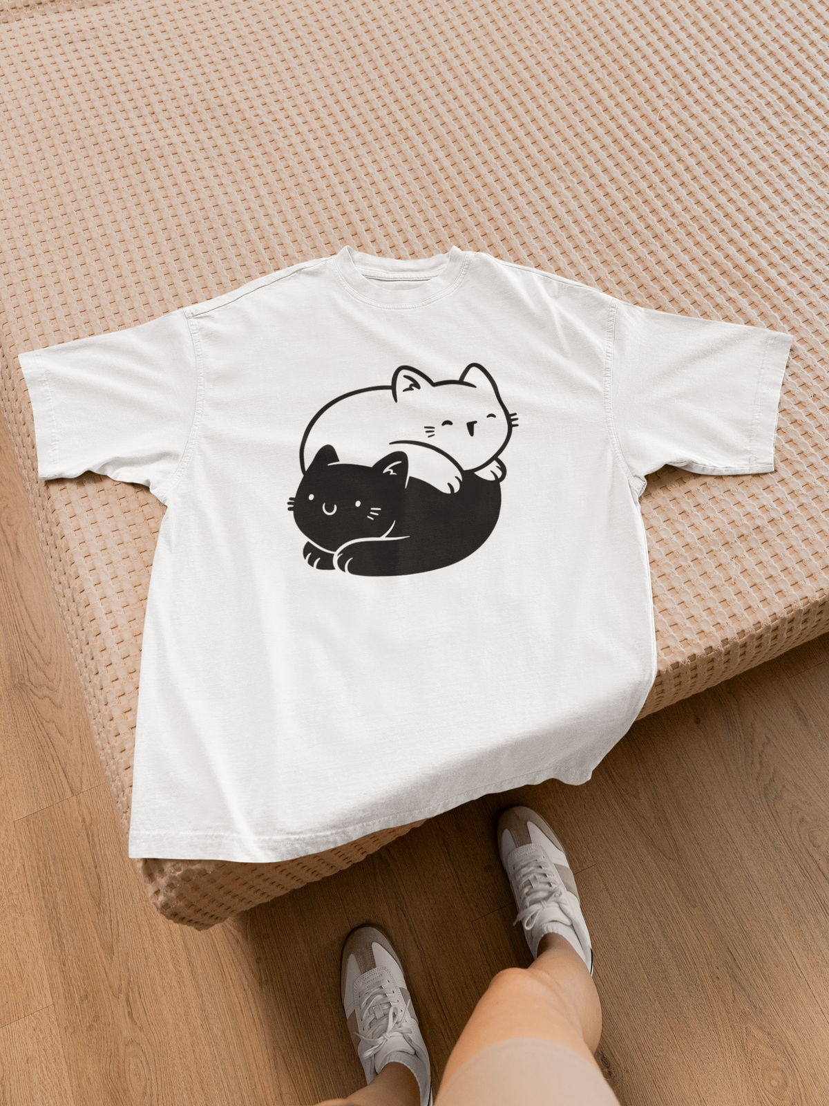 Yin Yang Cats T-shirt in white, flat lay on a wood bench, funny gift for cat lovers