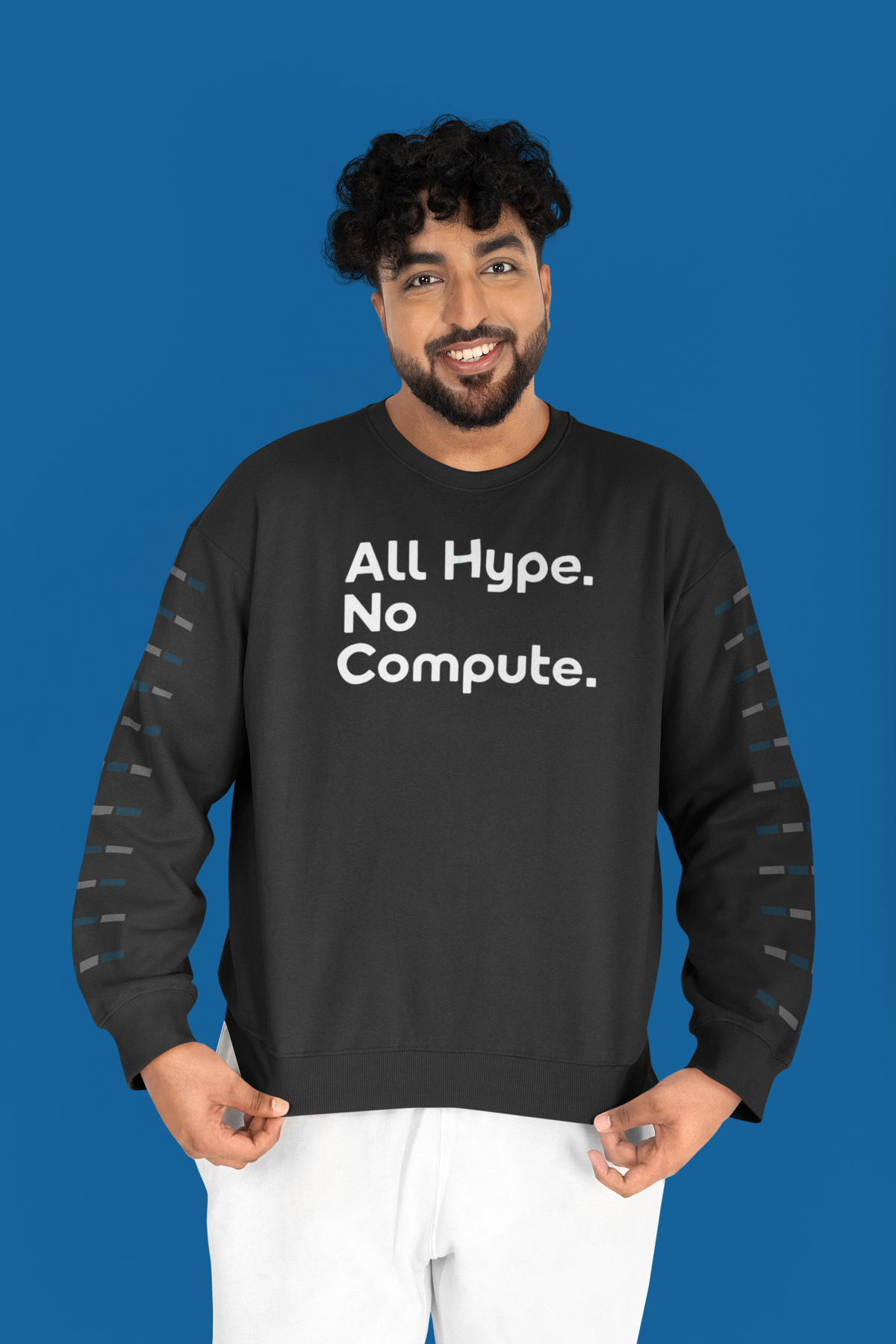 'All Hype. No Compute.' sweatshirt in black, curly haired man wearing it on blue background, funny programmer sweatshirt