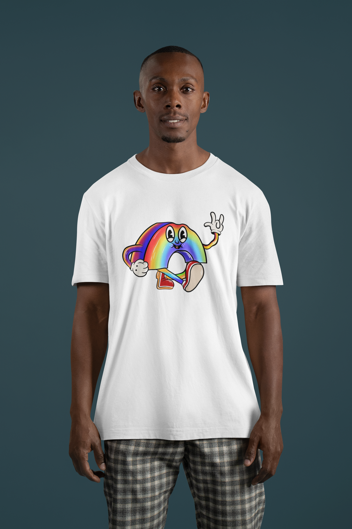 Cartoon rainbow character t-shirt in white, man wearing it on teal backdrop, funny quirky gift