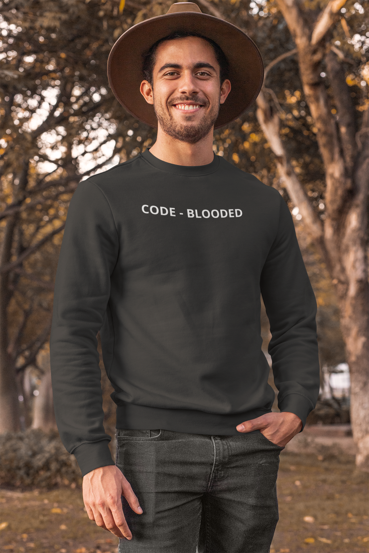 'Code - Blooded' sweatshirt in charcoal, man wearing it outdoors with hat, funny gift for programmers