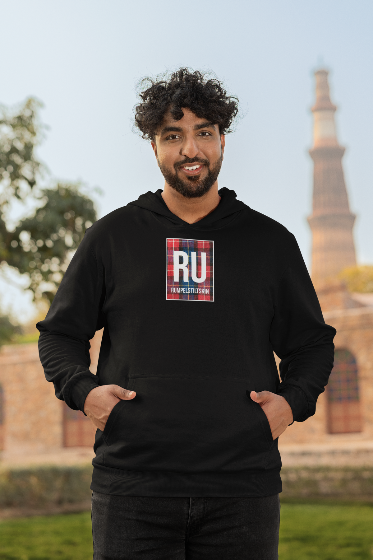 'RU Periodic Table Hoodie' in black, man by a historic building, Hoodie mockup, Geekpsters