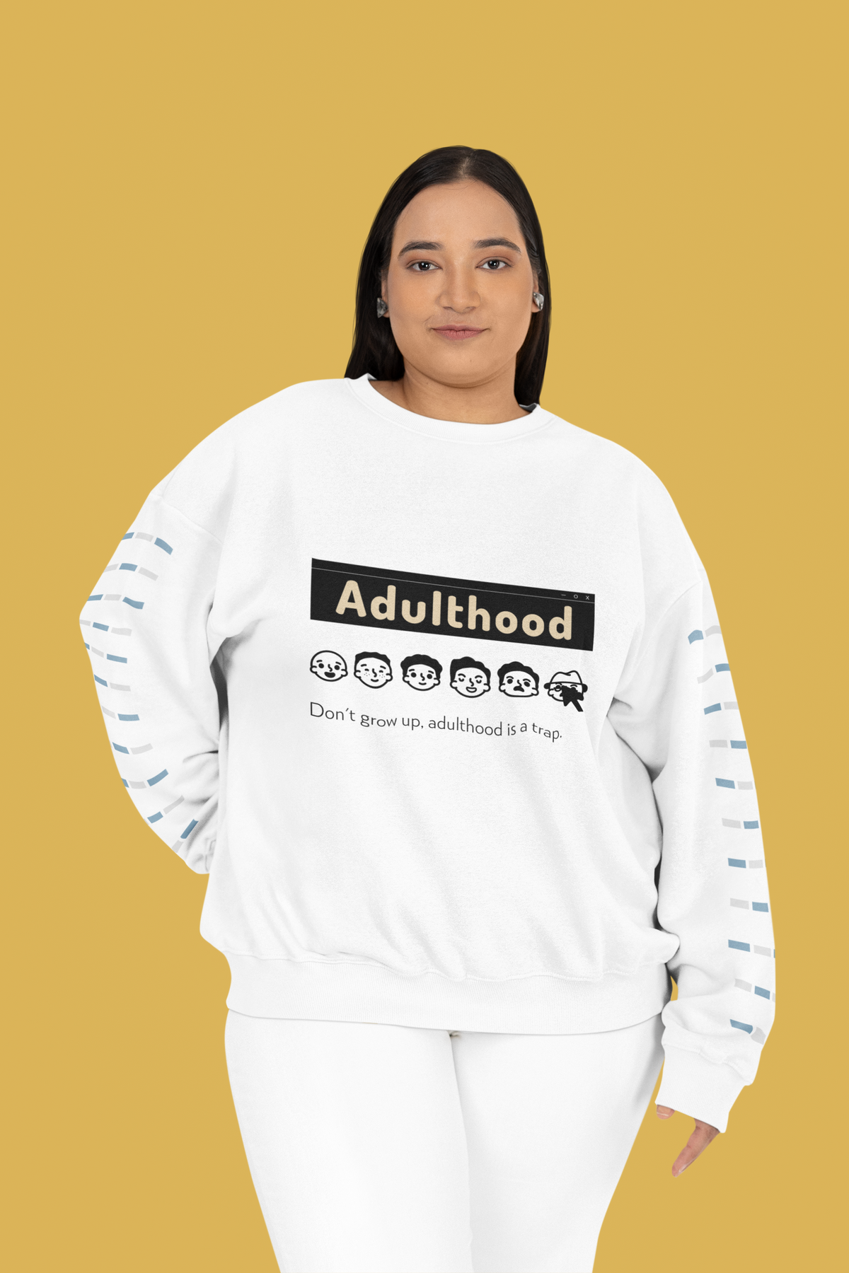 'Adulthood is a Trap' sweatshirt in white, woman wearing it on mustard backdrop, funny gift idea