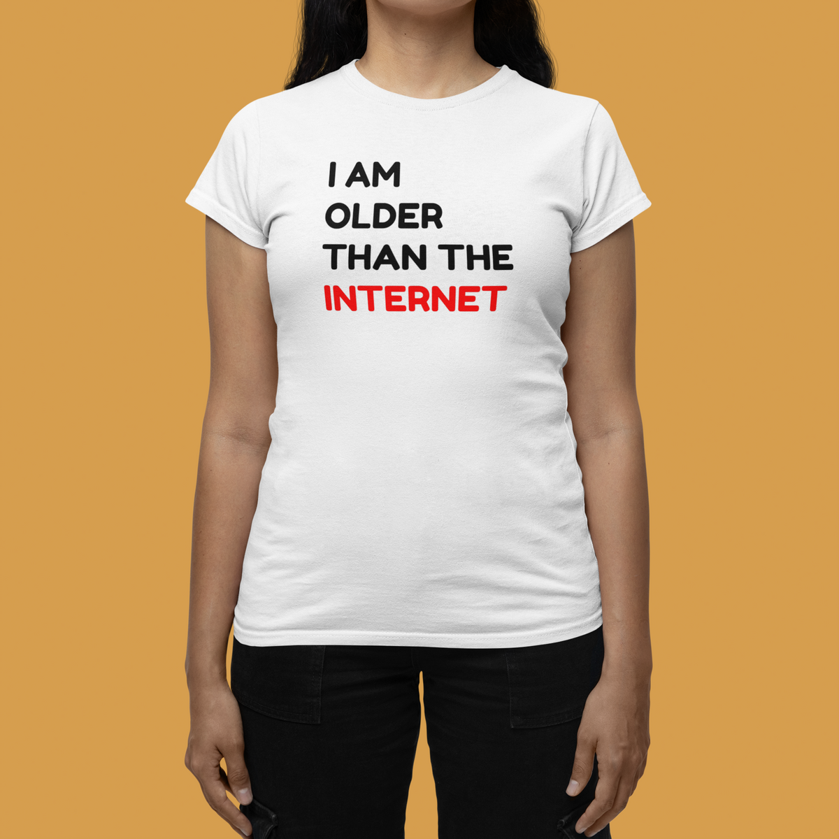 'I Am Older Than the Internet' women's tee in white, woman wearing it against a yellow backdrop, funny retro gift