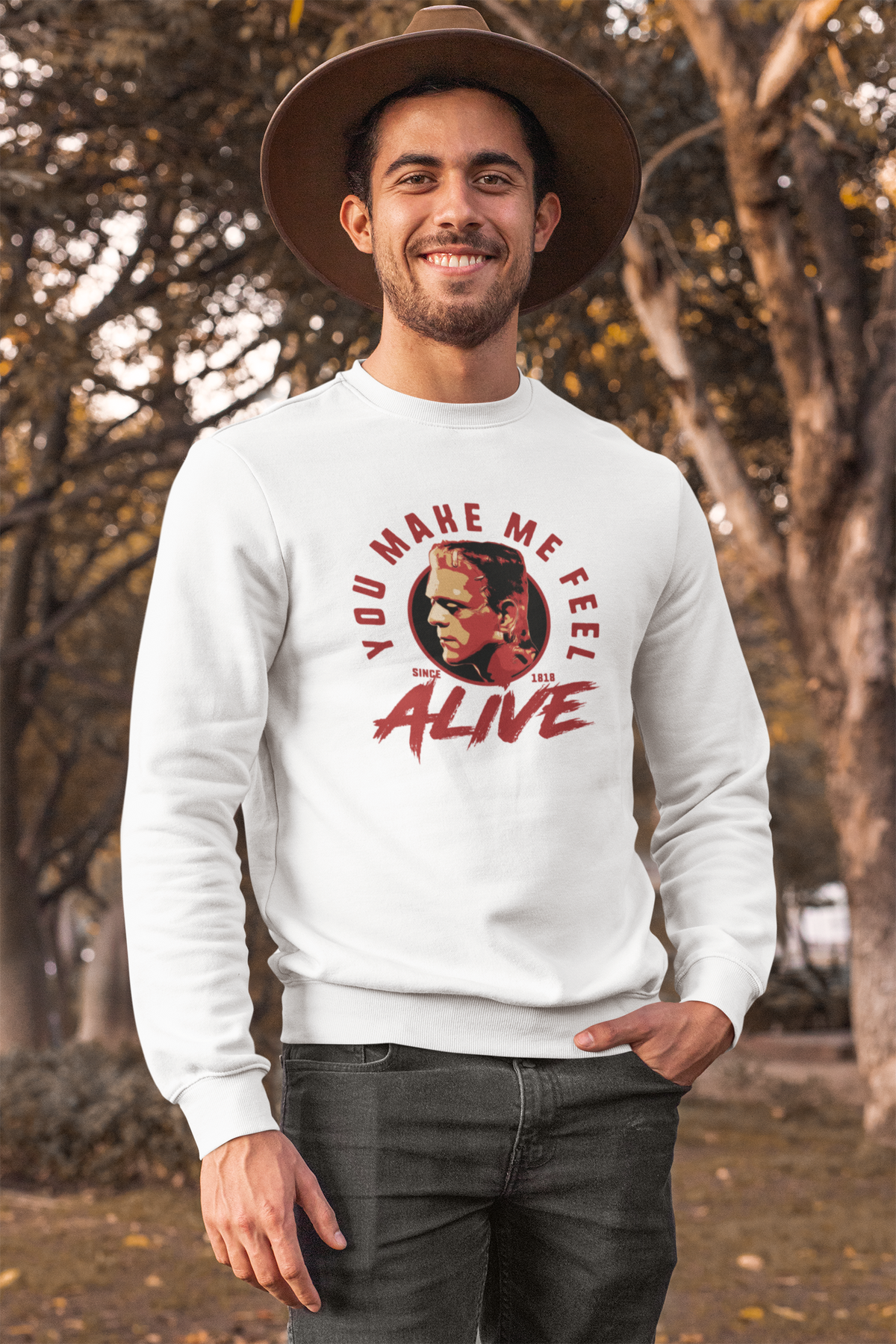 "You Make Me Feel Alive" portrait sweatshirt in white, man wearing it outdoors in a park, fan gift