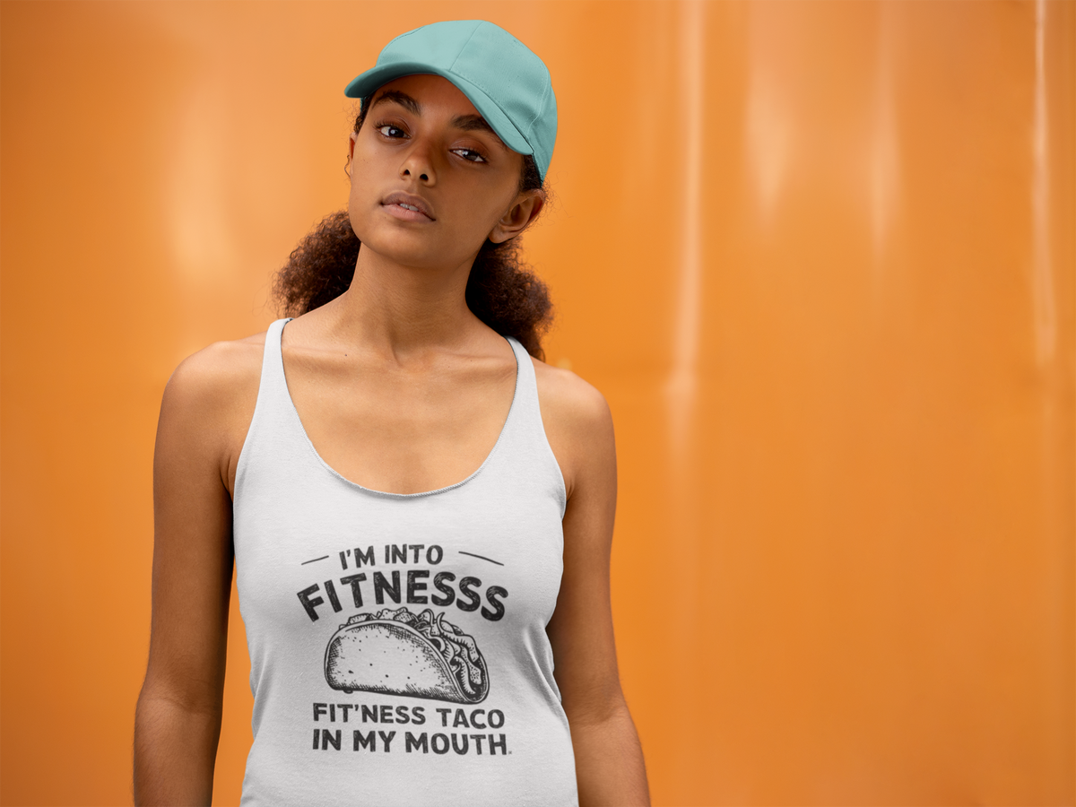 'I'm Into Fitness' racerback tank top in white, woman wearing it by an orange wall, Tank Top mockup, Geekpsters
