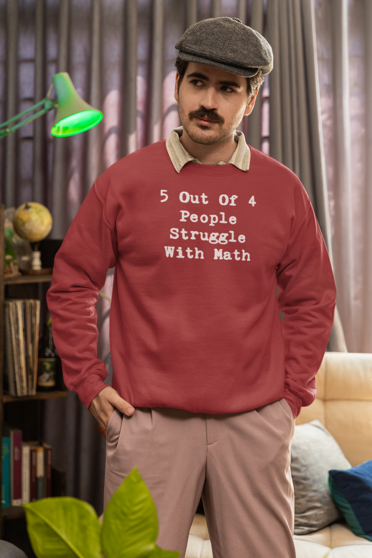 'Math Struggle For 5 Out Of 4 People Sweatshirt' in heather sport scarlet red, man in a cozy living room, Sweatshirt mockup