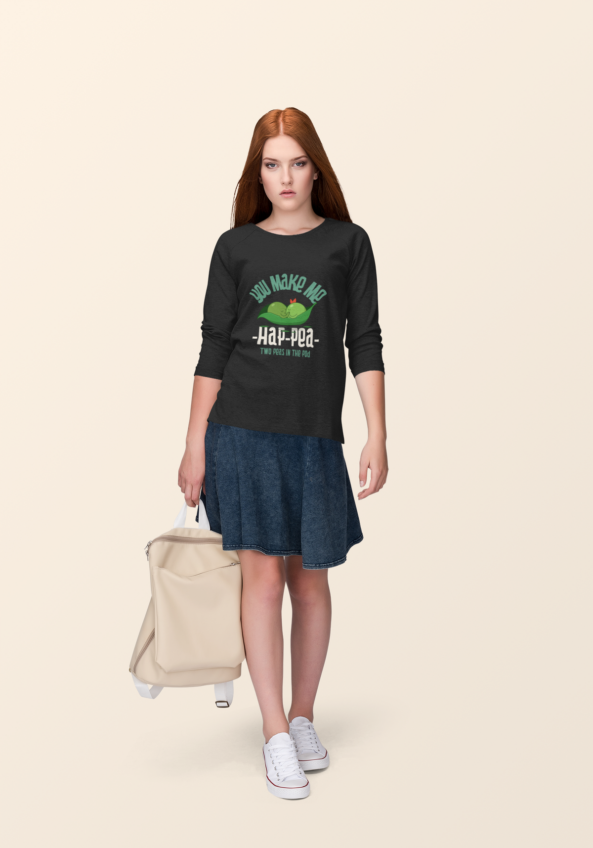 'You Make Me Ha-Pea' pea pun sweatshirt in black, woman wearing it, cream backdrop, veggie pun gift