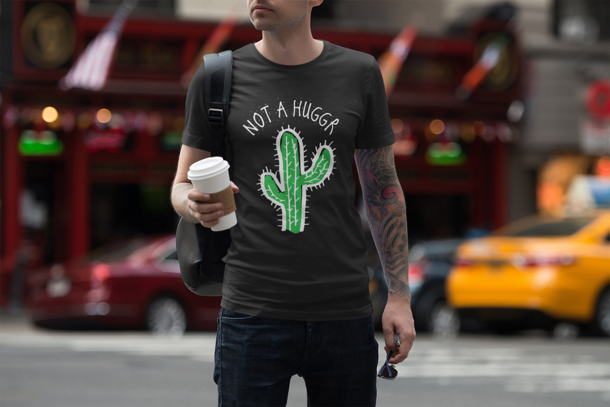 Not a Hugger cactus t-shirt in black, man wearing it walking a city street, funny sarcastic gift shirt