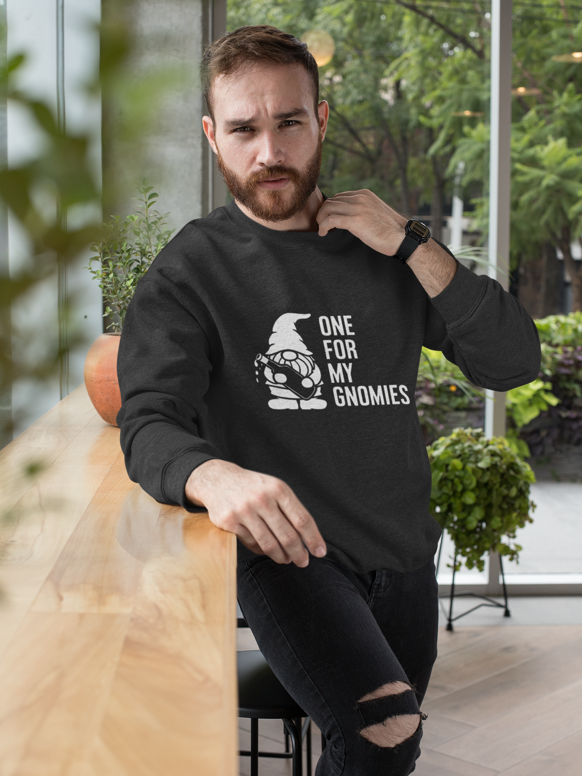 One For My Gnomies sweatshirt in black, bearded man wearing it outdoors in the city, funny gnome gift