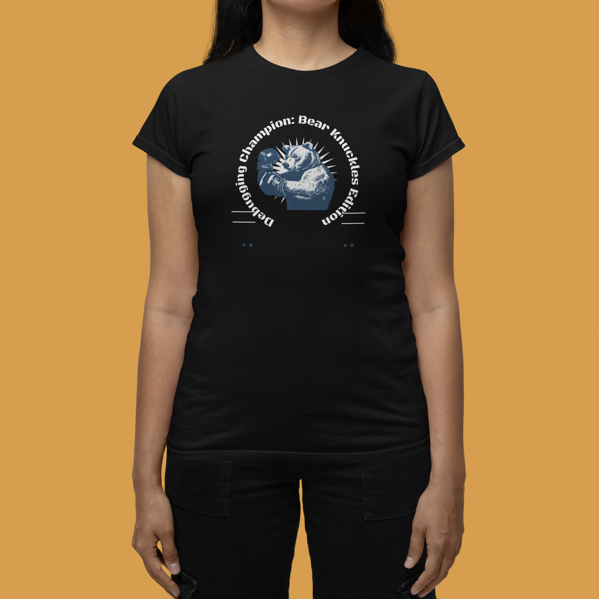 'Debugging Champion: Bear Knuckles Edition' women's tee in black, woman wearing it against a yellow backdrop, fun gift idea