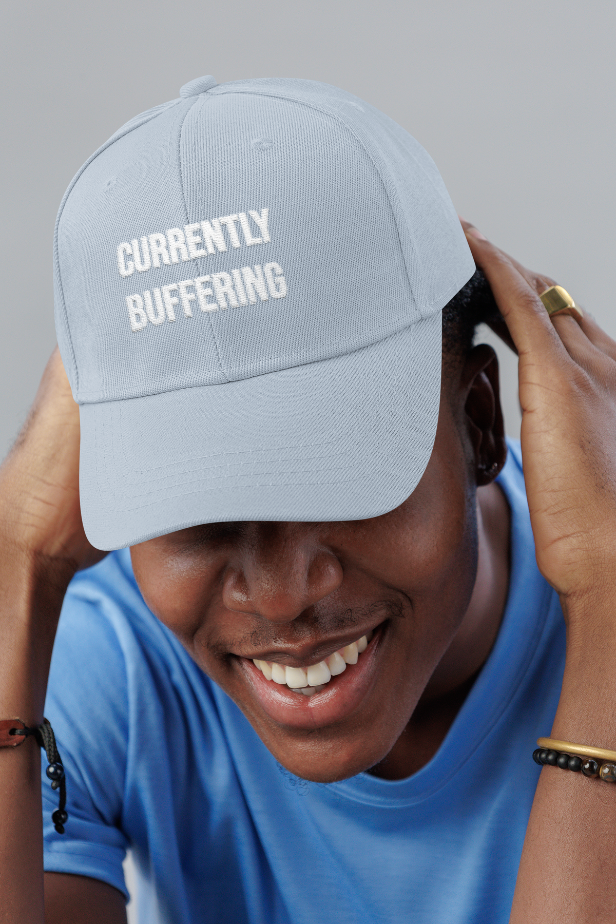 Currently Buffering dad cap, smiling man in a studio, lifestyle mockup, Geekpsters