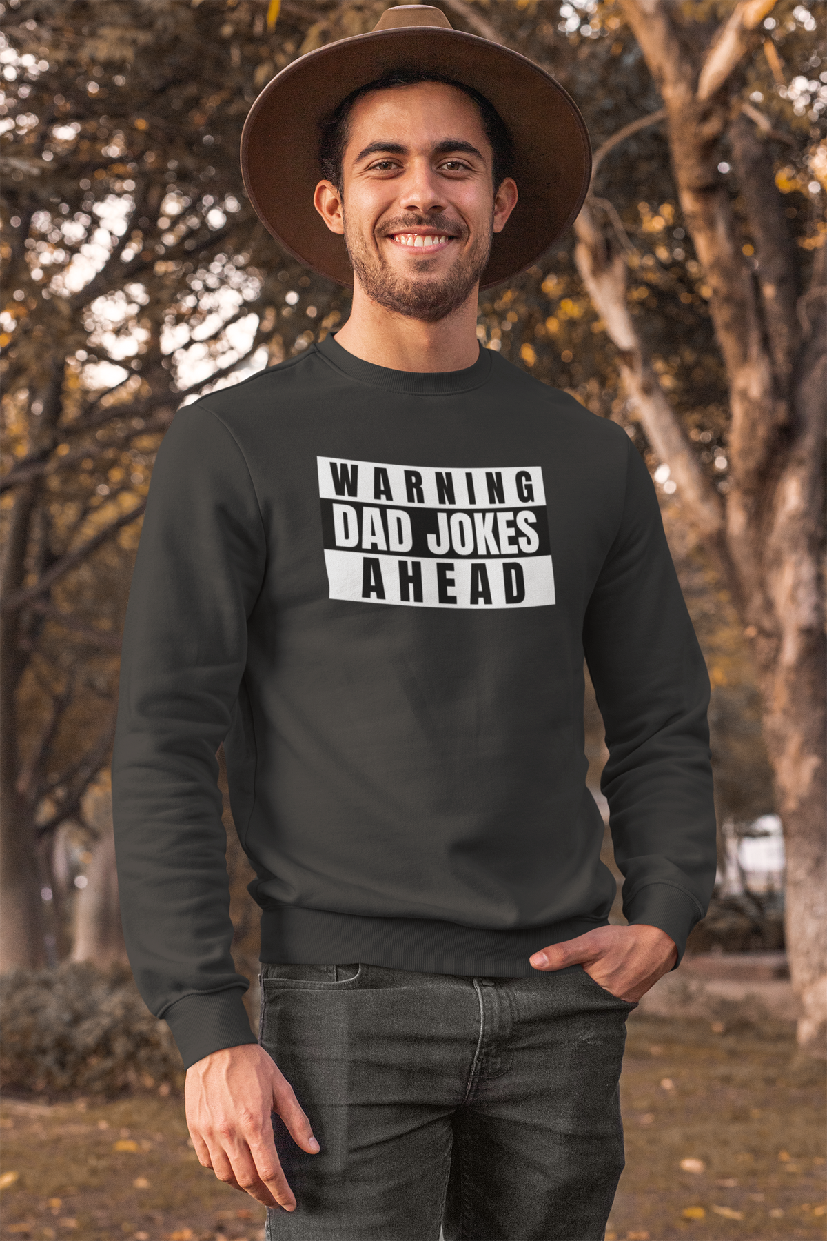 'Warning Dad Jokes Ahead' sweatshirt in black, man wearing it outdoors with hat, funny dad joke gift