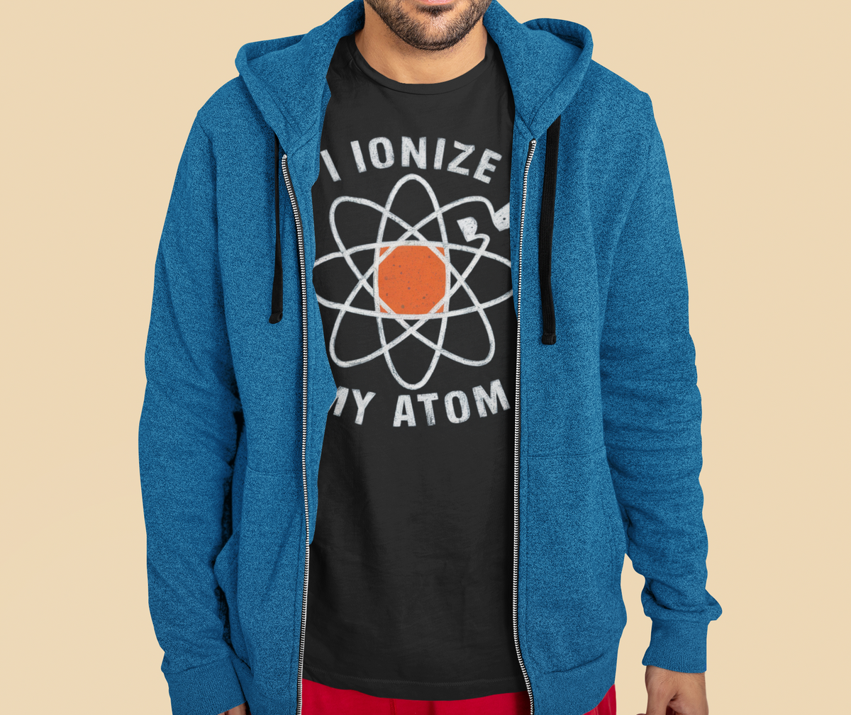 'I Ionize My Atom' zip hoodie in heather blue, man wearing it over black tee, funny chemistry gift