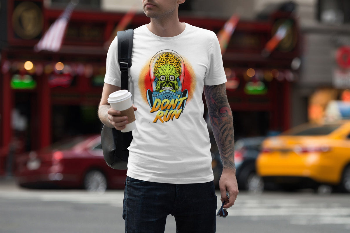Don't Run alien tee in white, man walking a city street with coffee, funny sci-fi gift