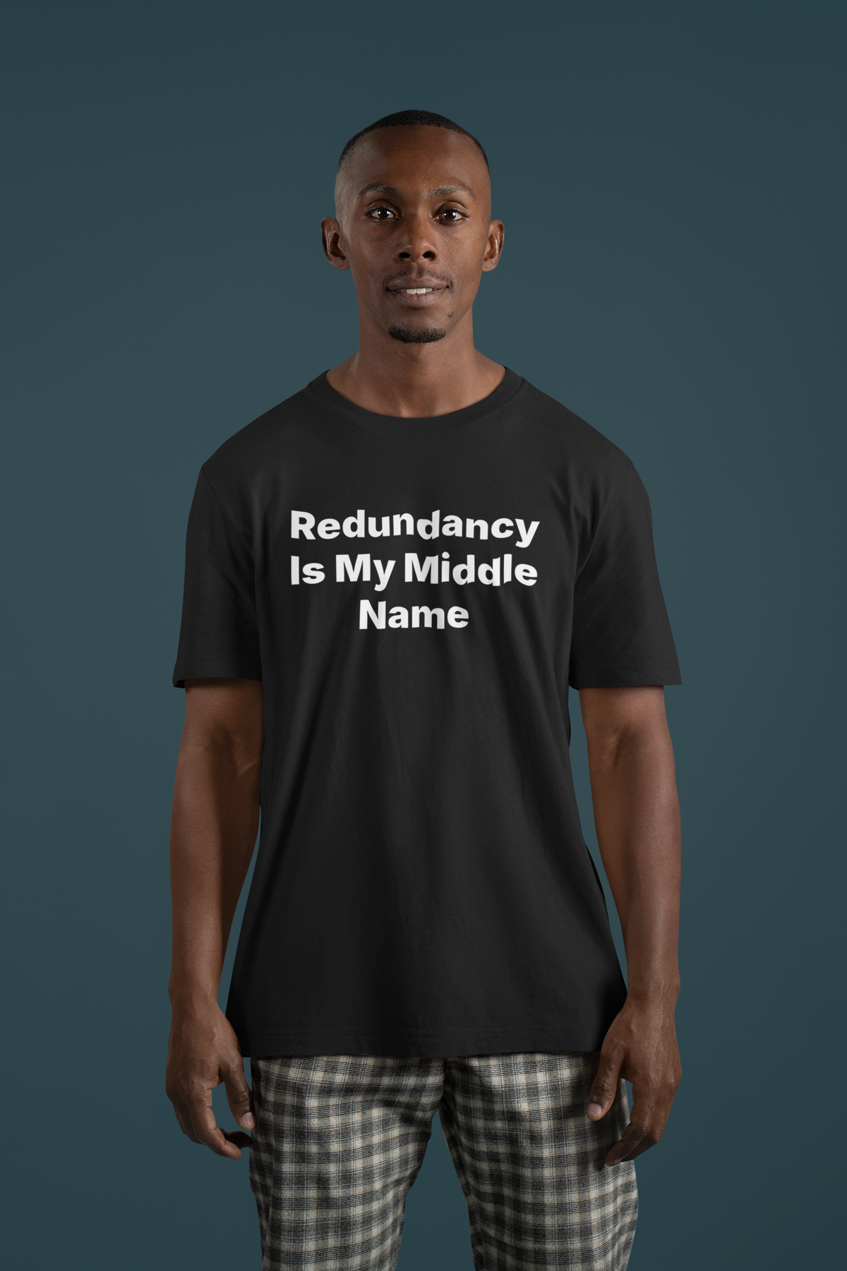 'Redundancy Is My Middle Name' t-shirt in black, man wearing it front view, funny sysadmin tee gift