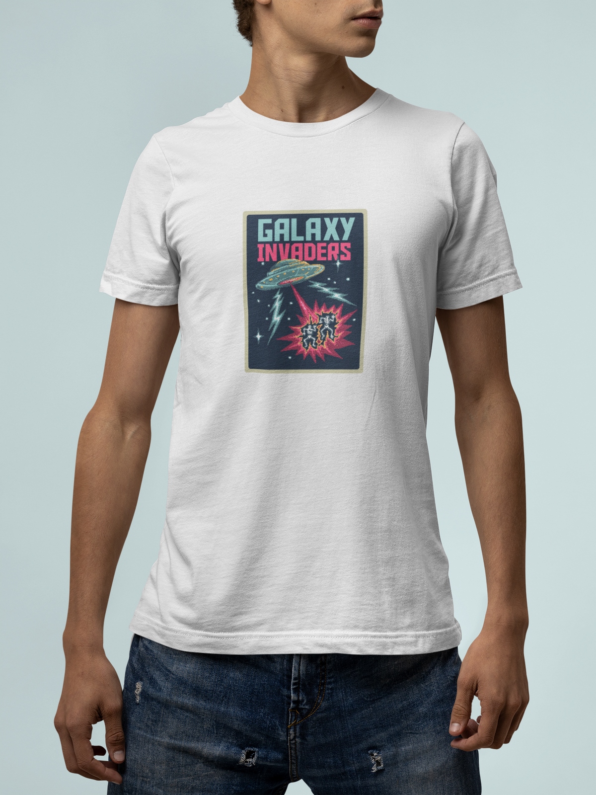 'Pixel Galaxy Invaders' t-shirt in white, man wearing it with jeans, T-Shirt mockup, Geekpsters