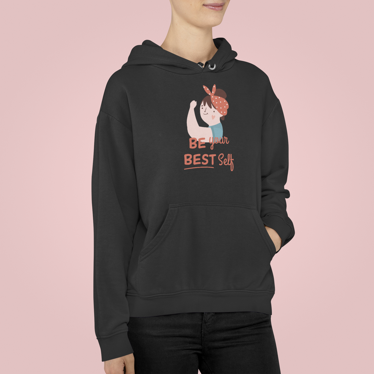 Be Your Best Self hoodie in black, woman wearing it against a pink backdrop, motivational gift