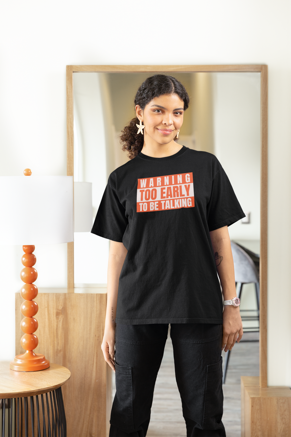 'Warning Too Early To Be Talking' t-shirt in black, woman wearing it indoors, funny sarcastic gift