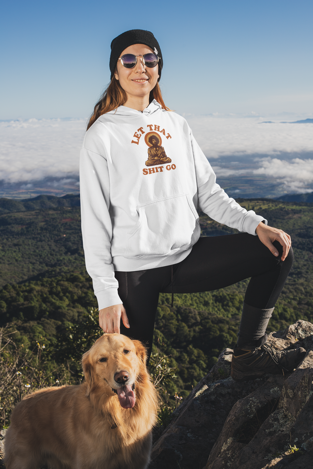 "Let That Shit Go" buddha graphic hoodie in white, woman wearing it outdoors with her dog, zen gift