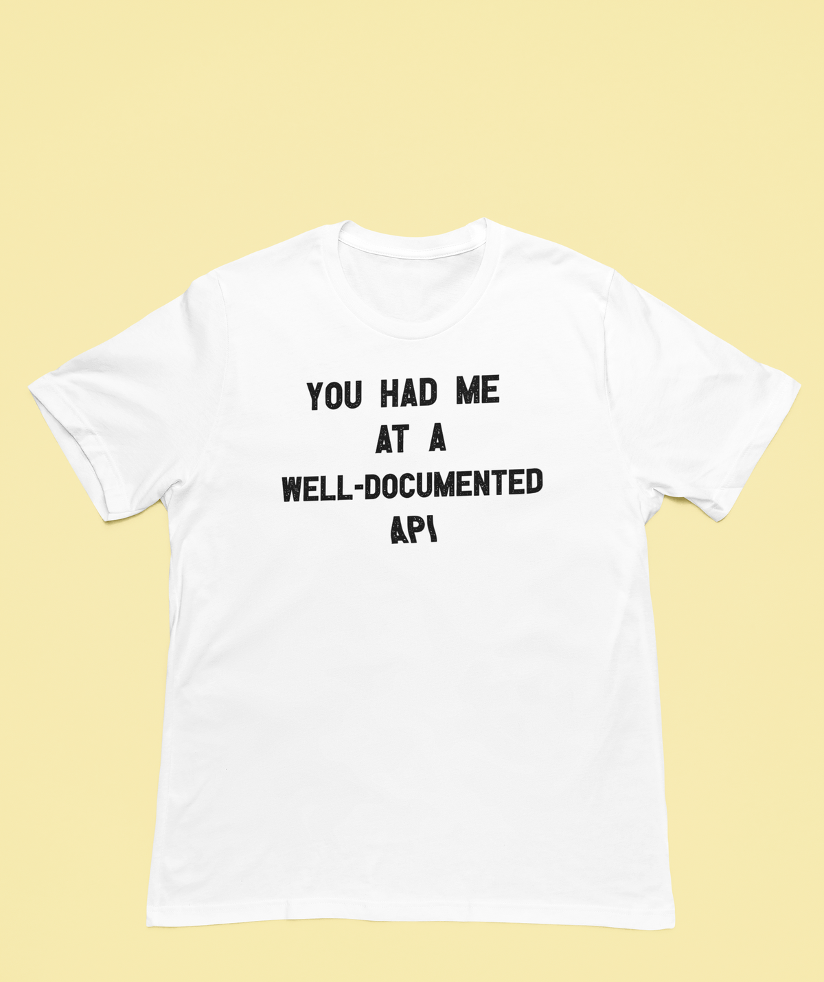 'You Had Me at a Well-Documented API' organic t-shirt in white, flat lay front, funny developer gift