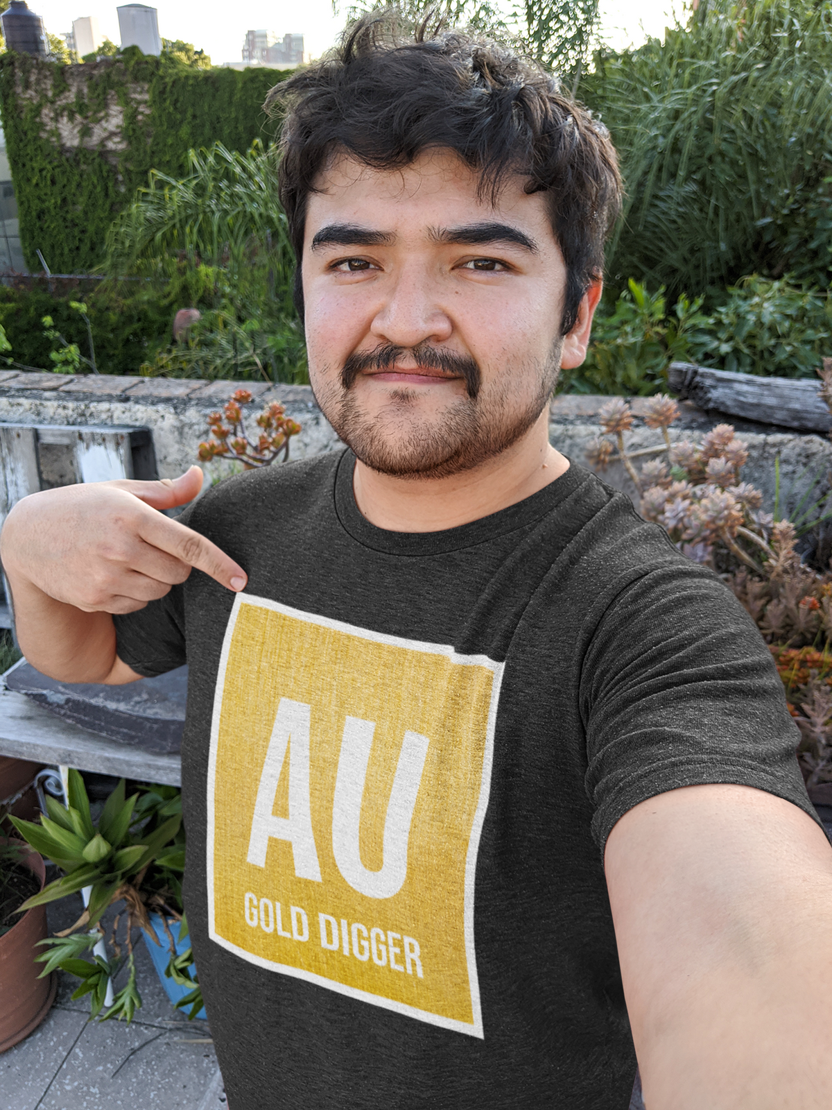 'Au Gold Digger' T-shirt in black, man pointing at the print, funny chemistry teacher gift