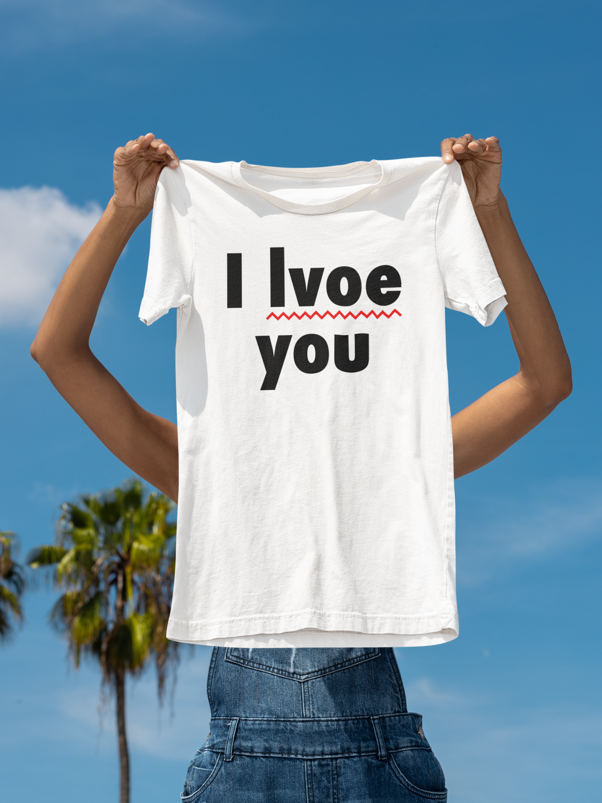 'I Lvoe You' typo tee in white, person holding it up outdoors under a blue sky, funny sarcastic gift shirt