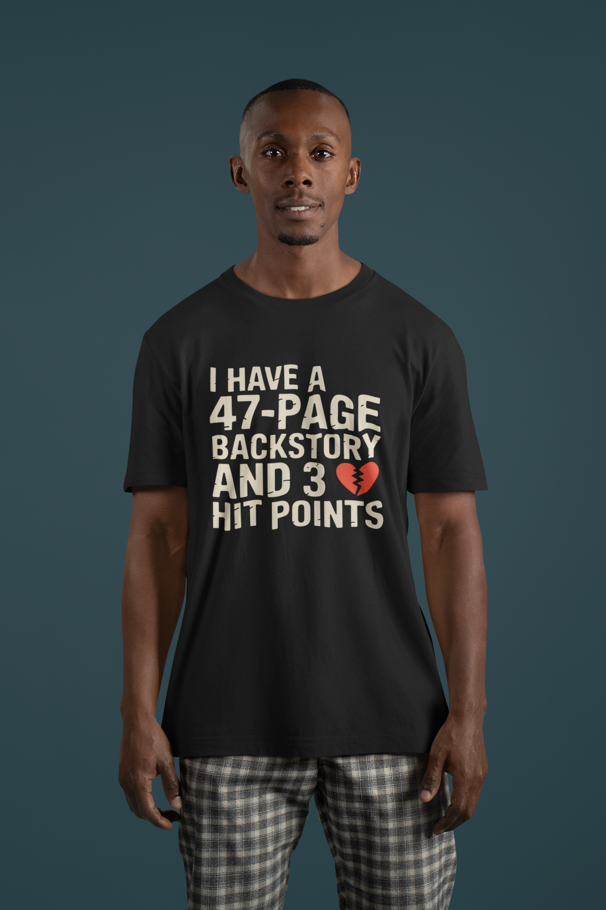 'I Have a 47-Page Backstory and 3 Hit Points' black tee worn by man on teal background, RPG gift
