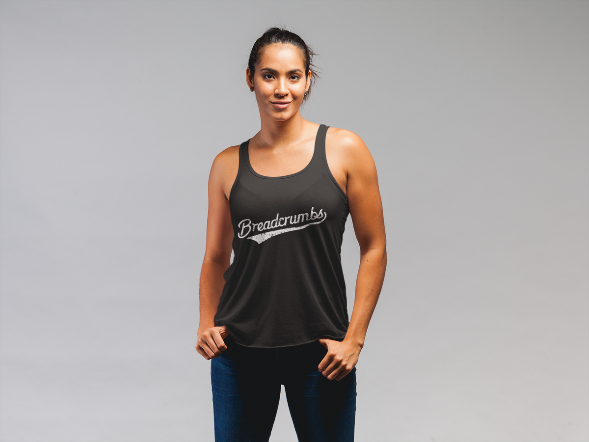 'Breadcrumbs' racerback tank in black, woman wearing it in a studio, funny script logo tank top gift