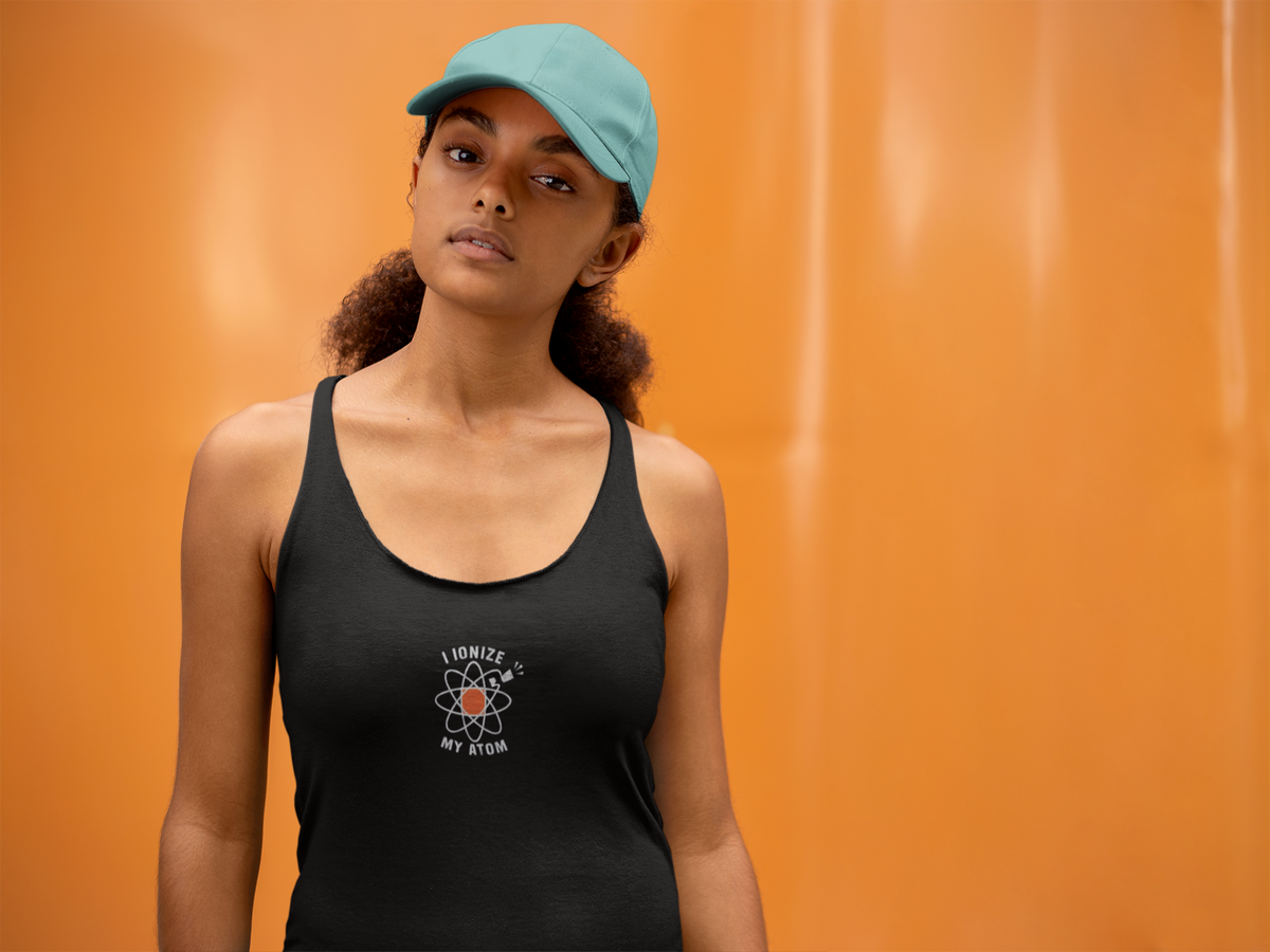 'Ionize Off My Atom Tank' in black, woman by an orange wall, Tank Top mockup, Geekpsters