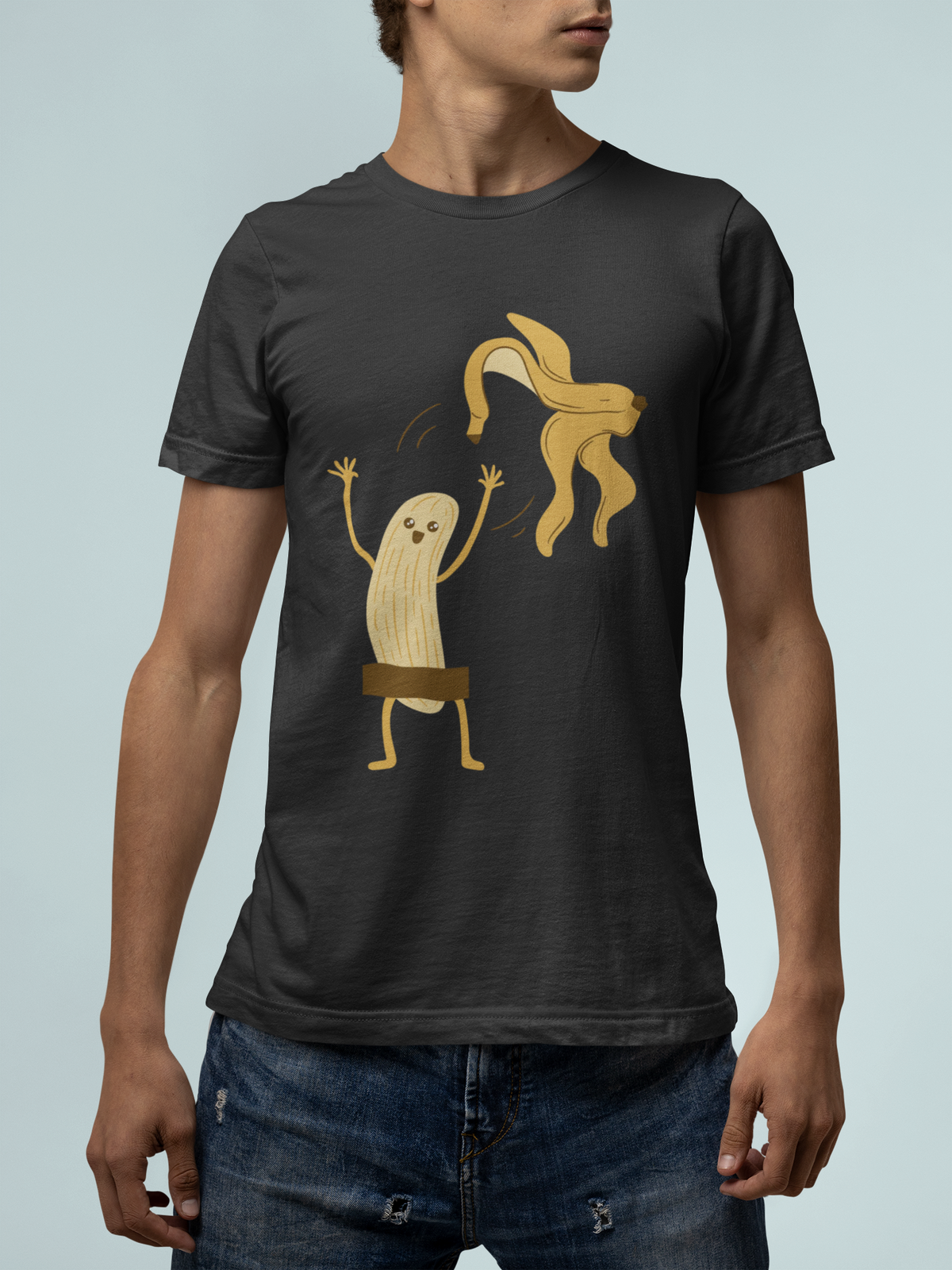 Naked Banana t-shirt in black, man wearing it on teal background