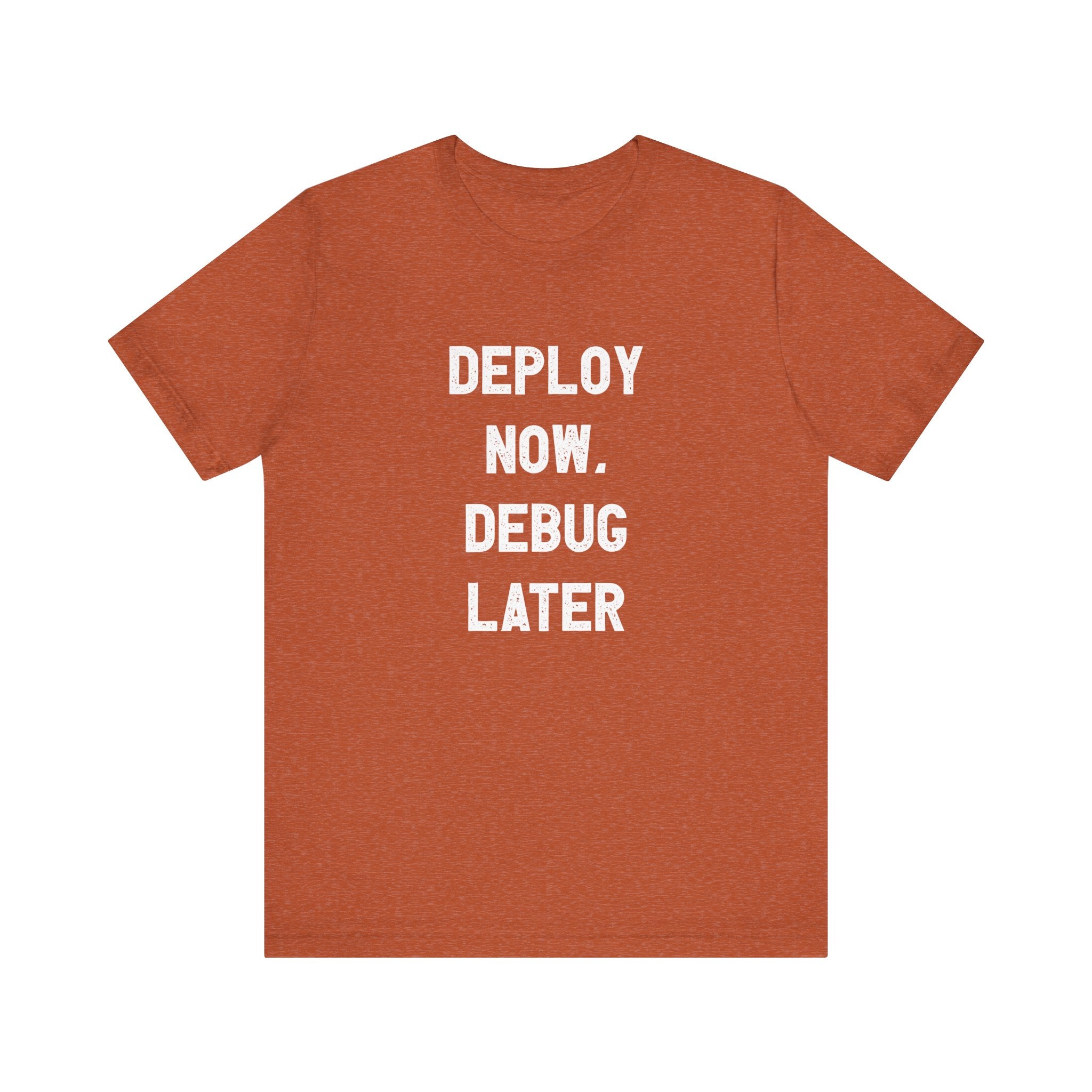 Orange t-shirt titled "Deploy Now, Debug Later," perfect for those passionate about coding.