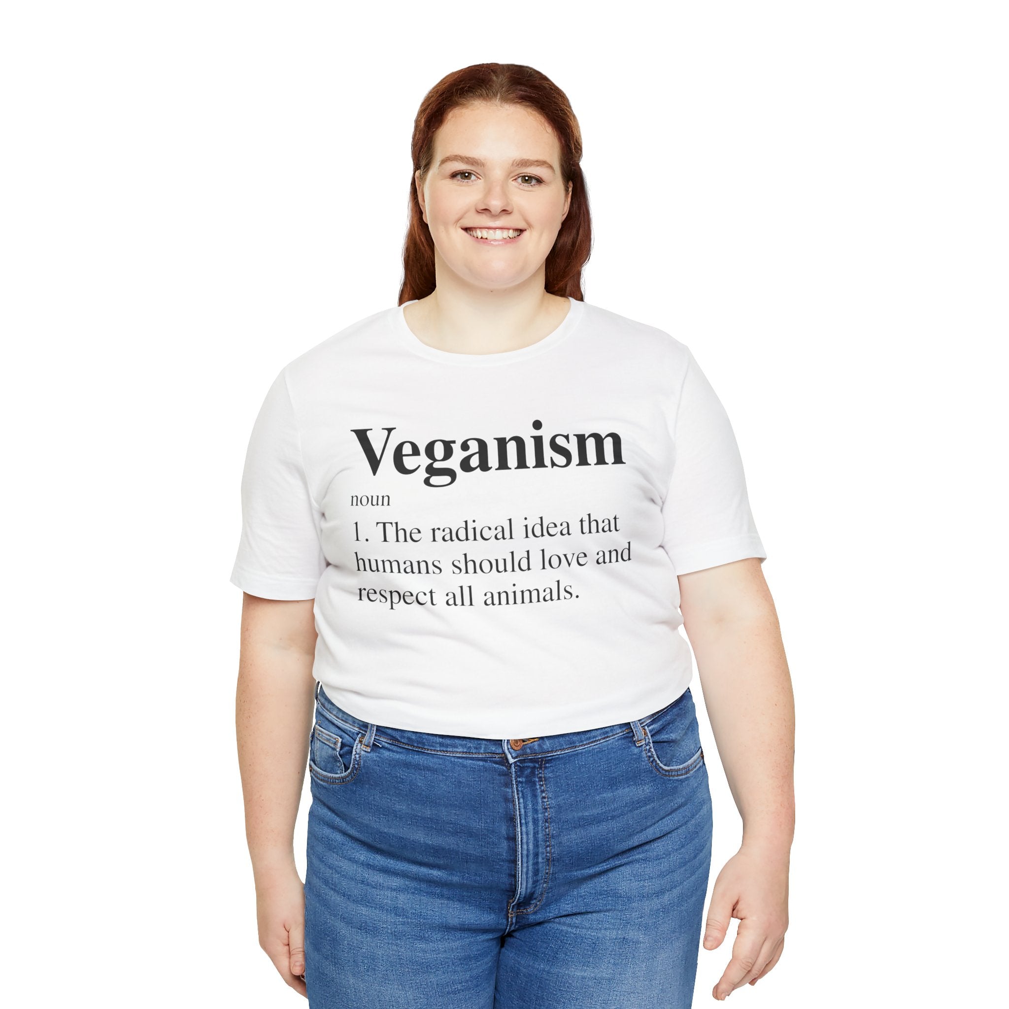 Sentence with Product Name: Woman in a white Veganism T-Shirt, paired with blue jeans, smiling at the camera.