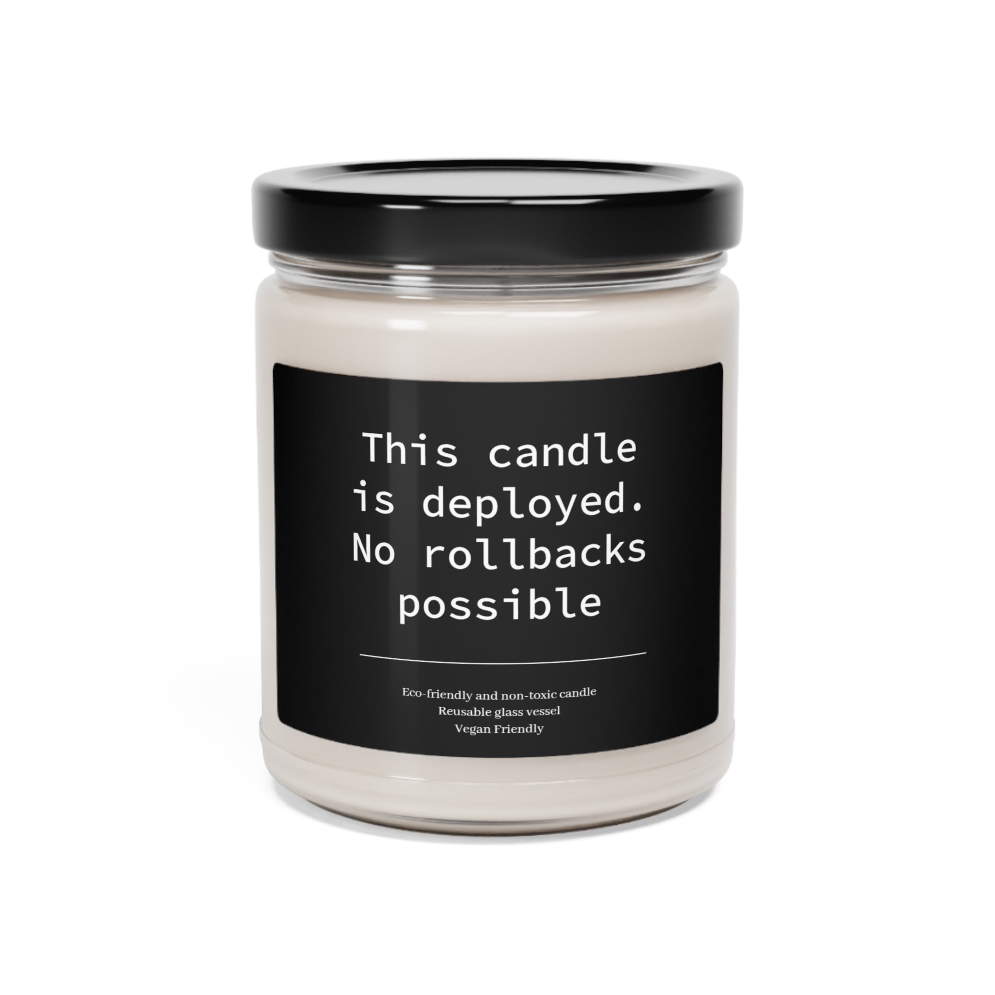 A This Candle Deployed - No Rollbacks- Scented Soy Candle, 9oz with a humorous label that reads "this candle is deployed. no rollbacks possible," featuring a natural soy wax blend.