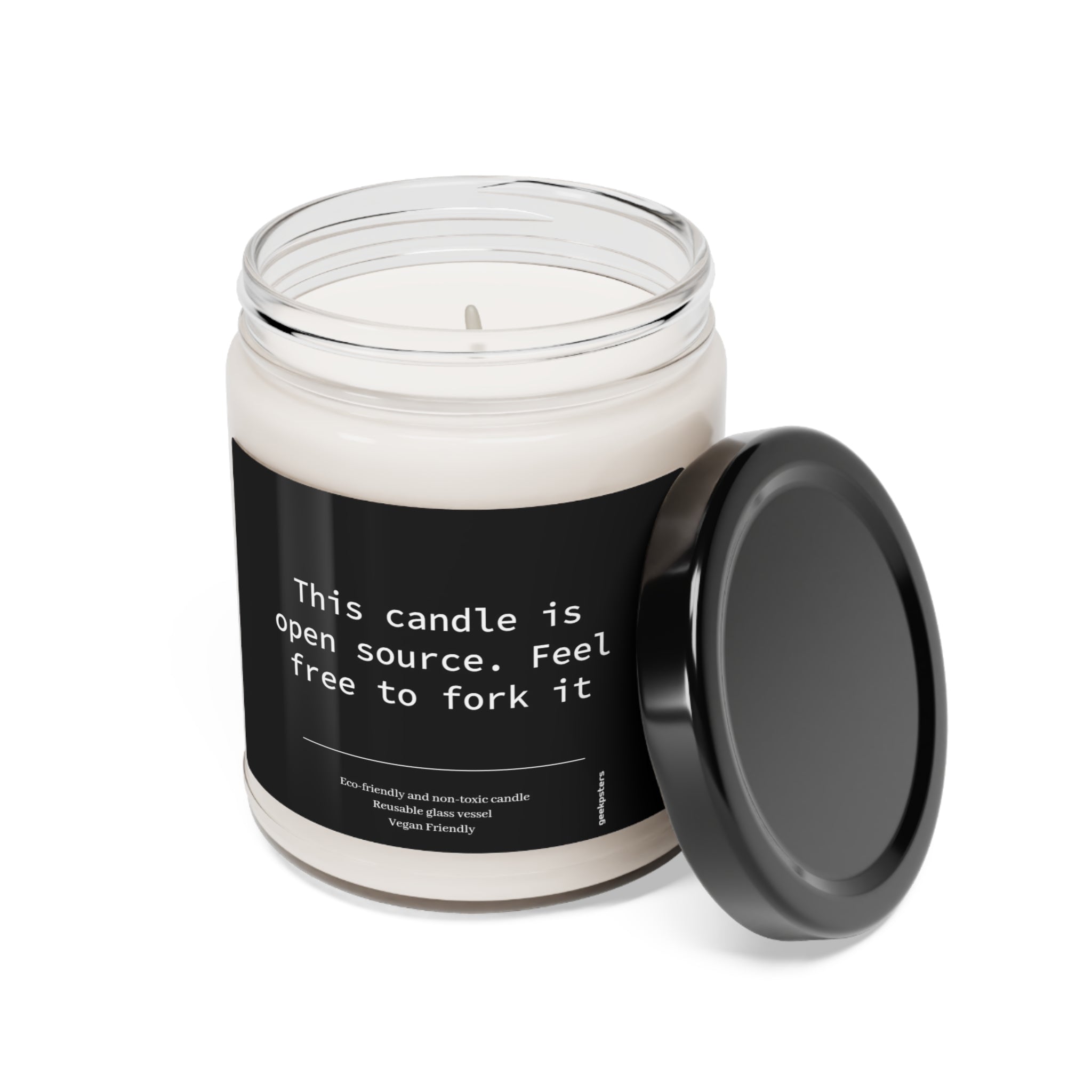 This Candle is Open Source - Feel Free to Fork It - Scented Soy Candle, 9oz with a humorous label that reads "this candle is open source. feel free to fork it," featuring a cotton wick, presented next to its detached black lid on a white background