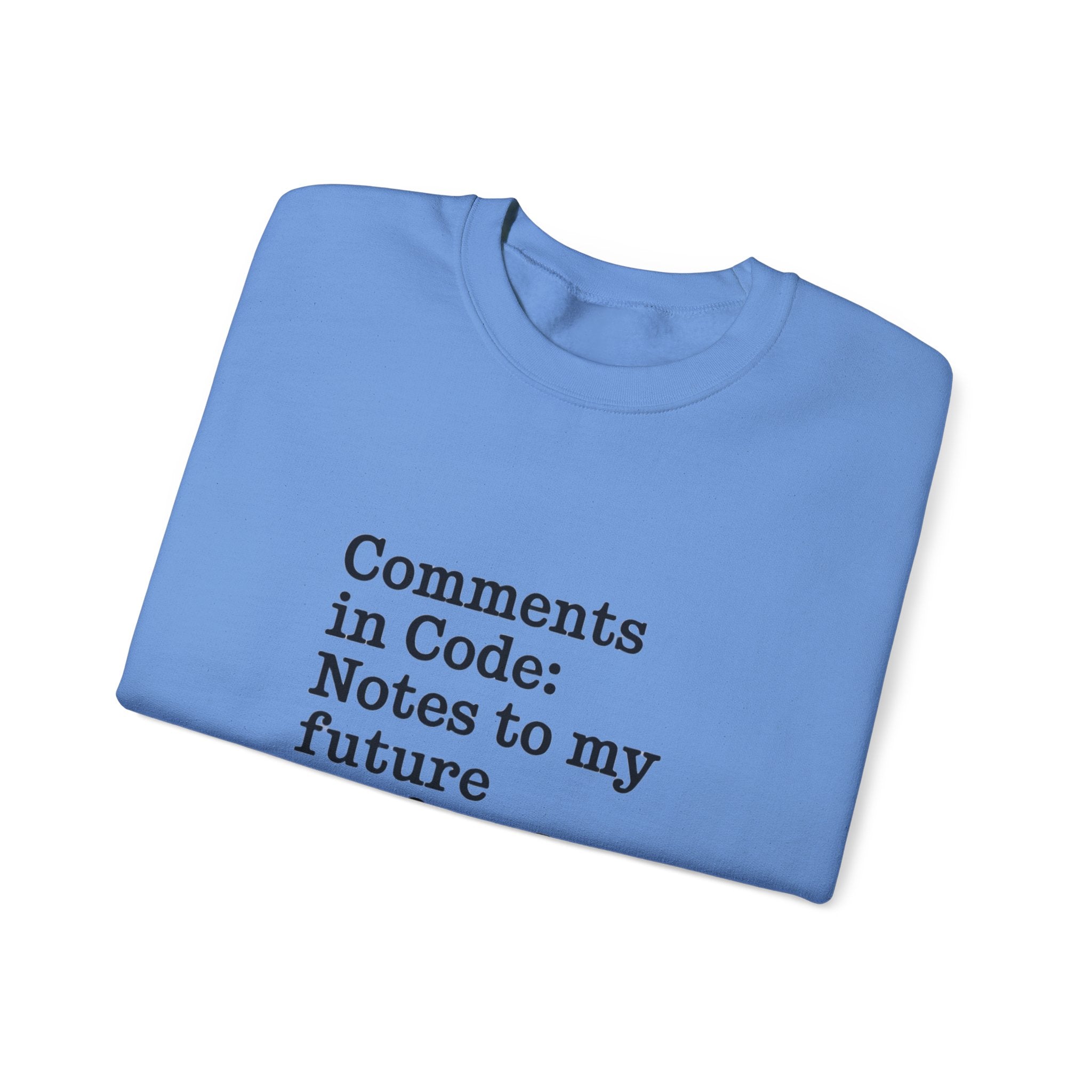 A folded blue "Comments in code - Sweatshirt" made from sustainable cotton, featuring the text "Comments in Code: Notes to my future" printed in black on the front.