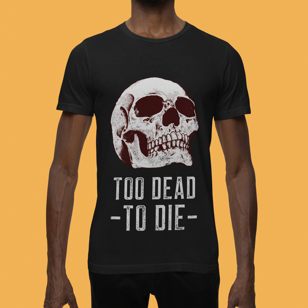 'Too Dead To Die' skull t-shirt in black, man wearing it on orange background, funny edgy gift idea