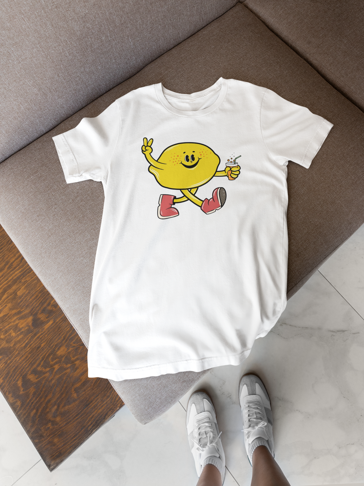 Cartoon lemon t-shirt in white, lifestyle flat lay on wood floor with sneakers, funny citrus lover gift