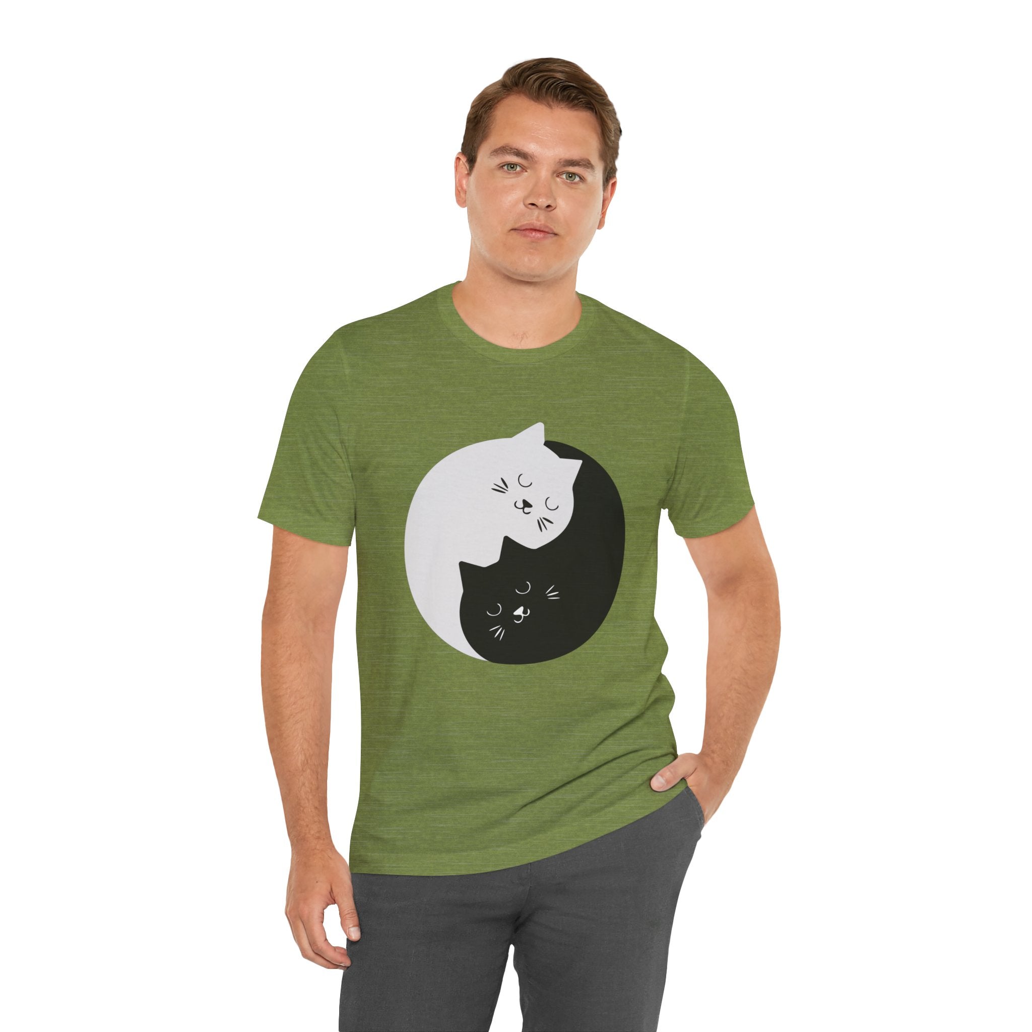 Man in a green YING-ANG KITTIES T-shirt, standing against a plain background.