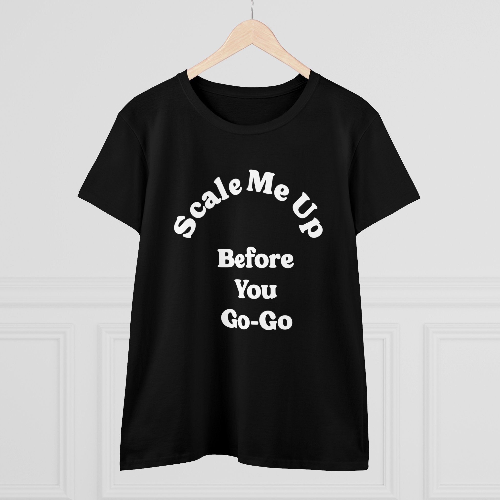 Essential in any wardrobe, the "Scale Me Up Before You Go Go" women's tee is shown in black on a hanger, showcasing its playful message in a crisp white font.